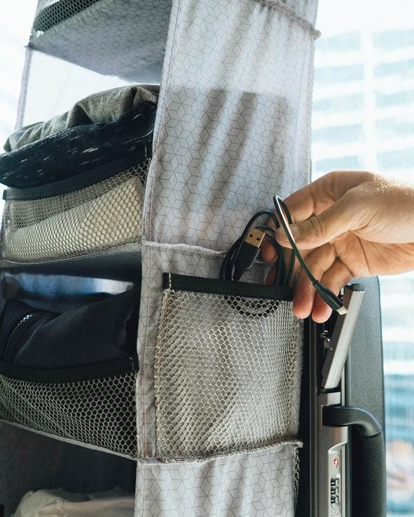 This Clever Carry-On Suitcase Has Its Own Retractable Shelving System