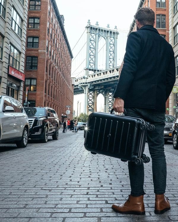 This Clever Carry-On Suitcase Has Its Own Retractable Shelving System