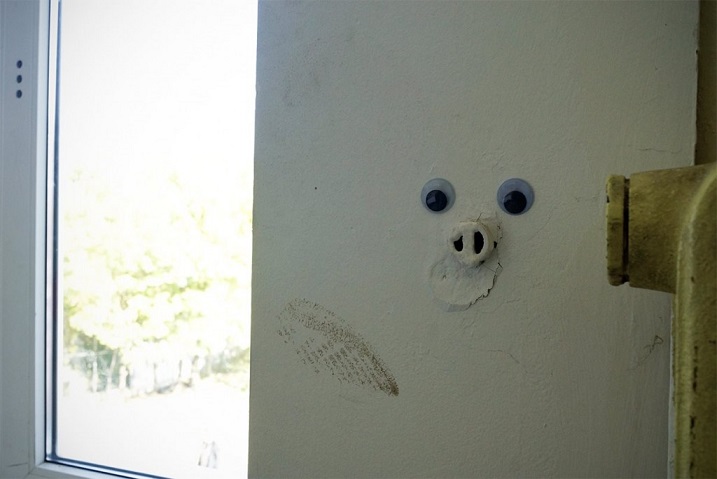 pipe sticking out of a wall with googly eyes