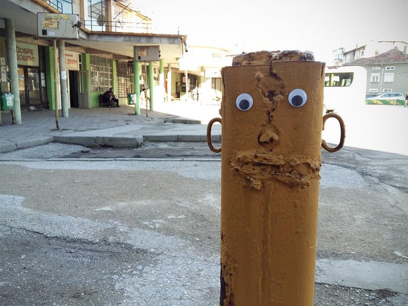 Street post with googly eyes