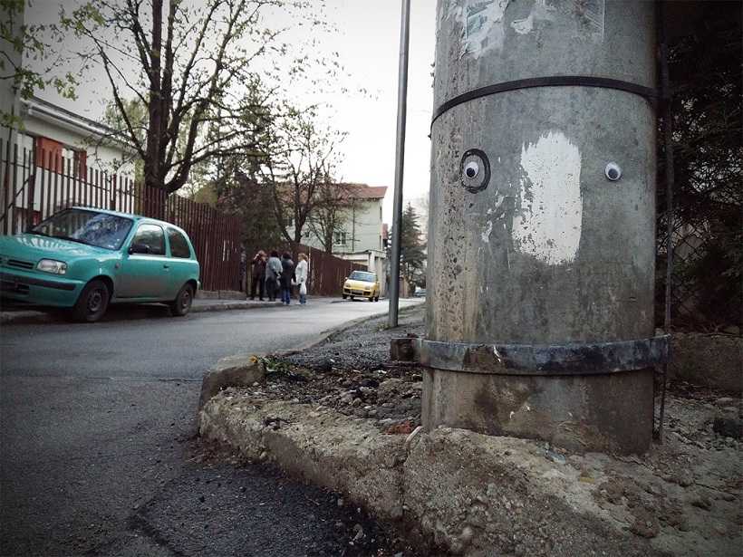 Street post with googly eyes
