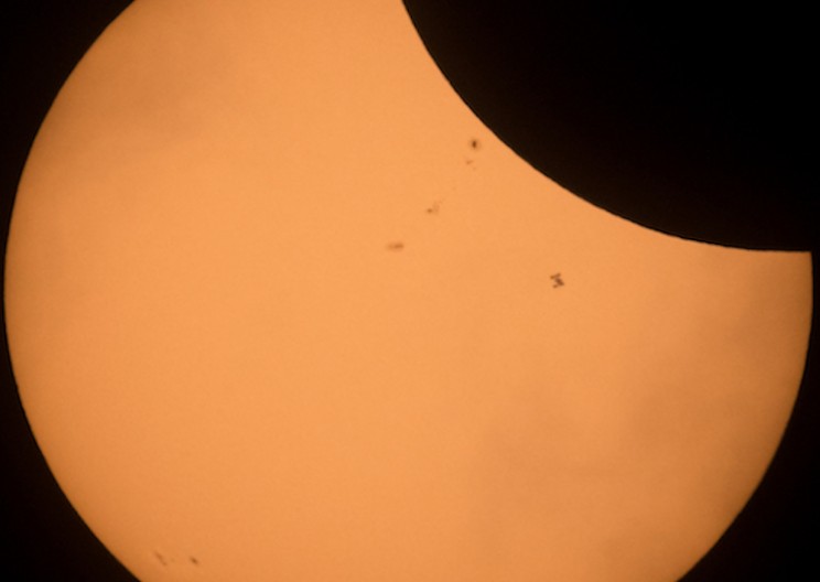 NASA Photographer Captures the Incredible Moment the ISS Flies Across the Solar Eclipse