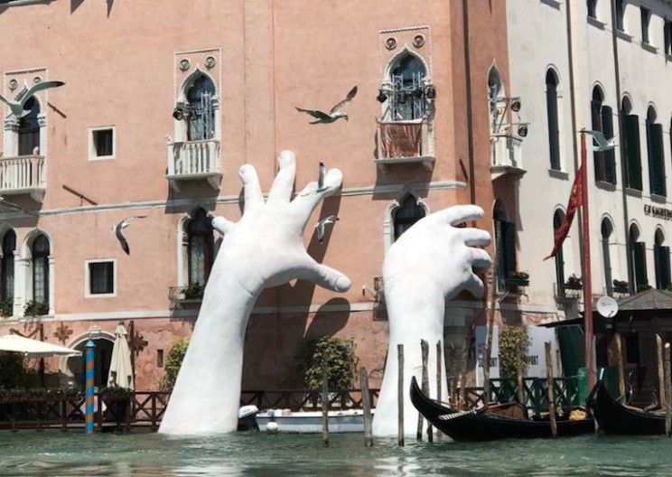 Artist Installs Giant Hand Sculptures in Venice Canal to Highlight Climate Change
