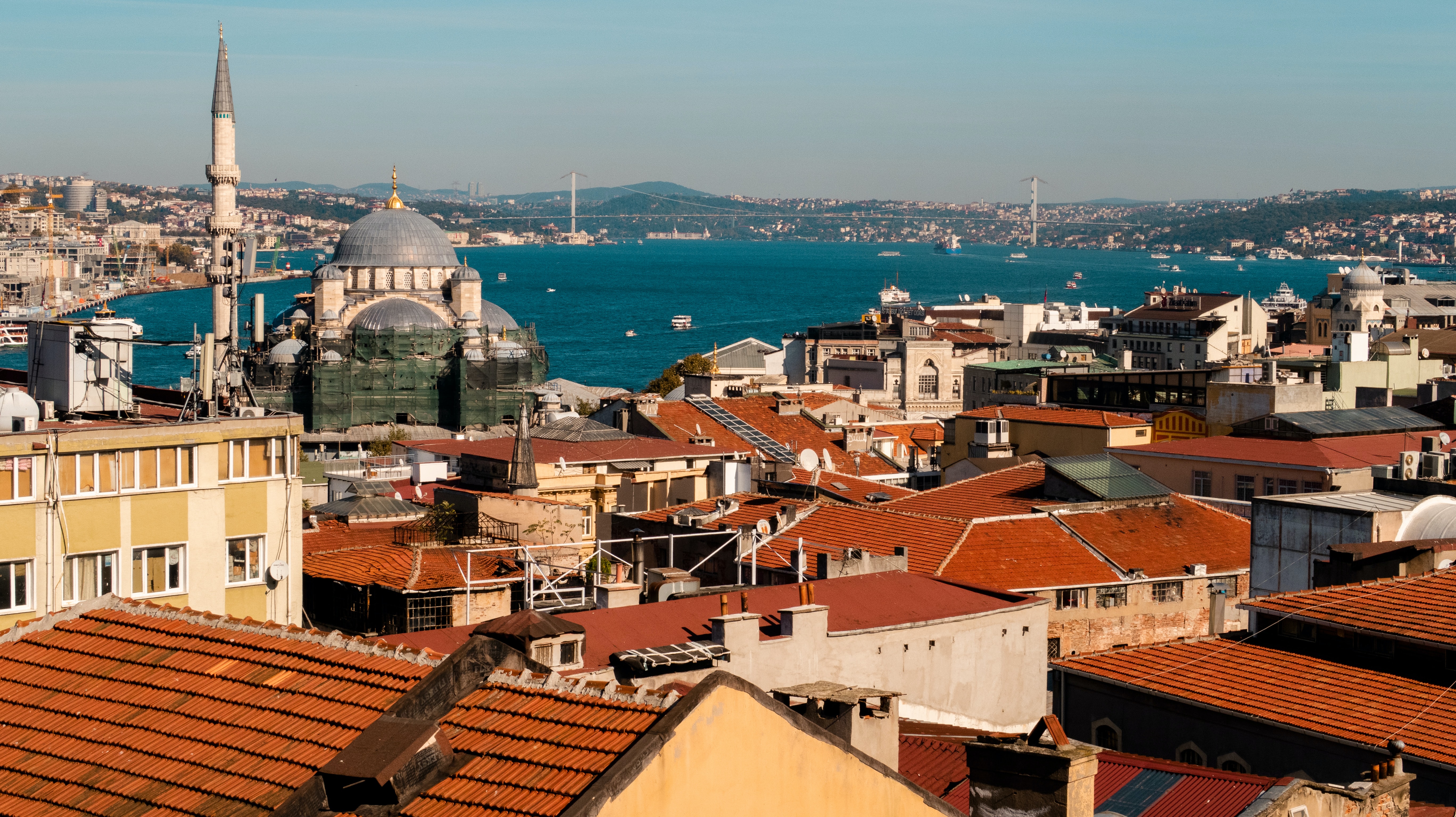 Red rooftops shine in the sun as the Bosphorus stretches into the distance.