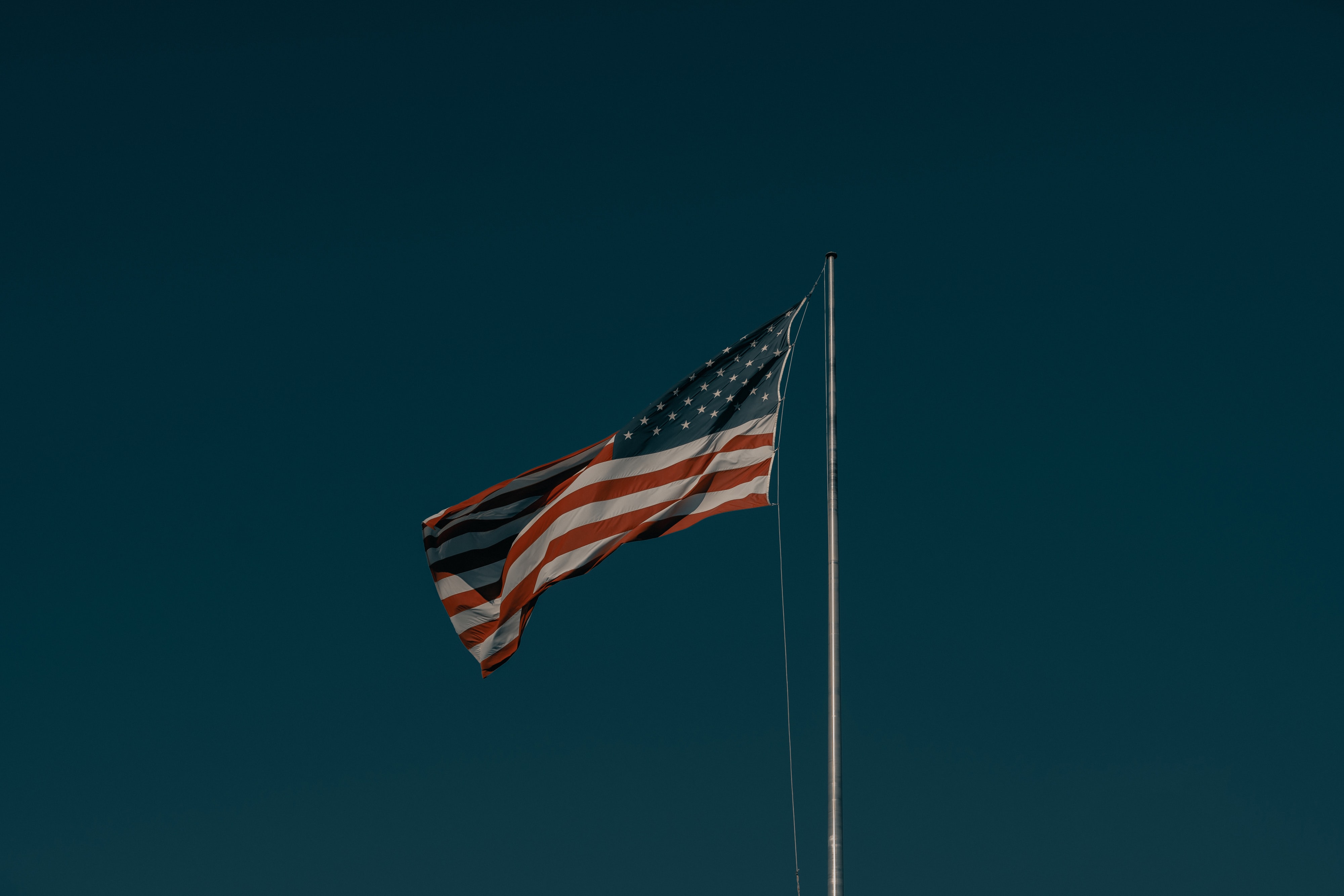 The American flag set against a dark blue background.