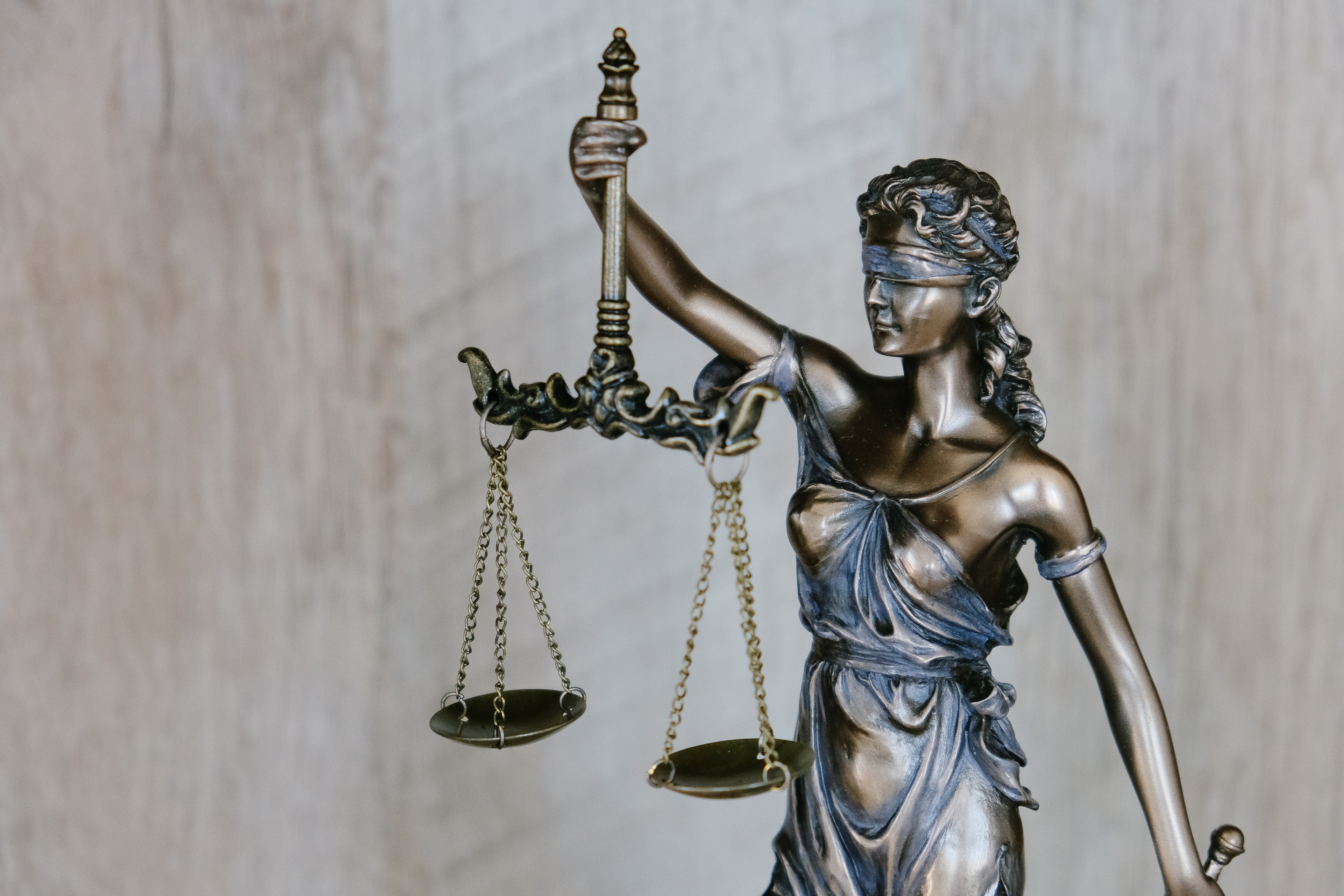 A small bronze statue of Lady Justice in a law firm.