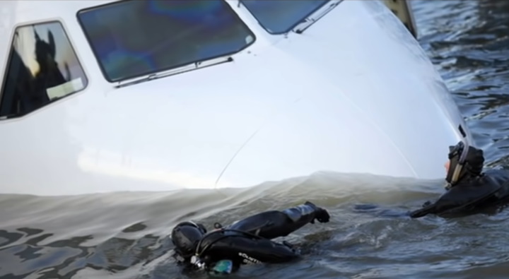Scuba divers enter submerged plane Scuba divers enter submerged plane