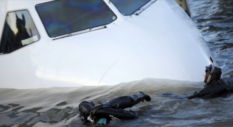 Scuba divers enter submerged plane Scuba divers enter submerged plane