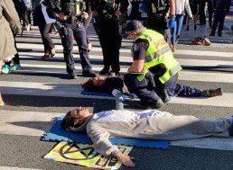 Australian Environmental Activists Glue Themselves to Busy Street in Protest