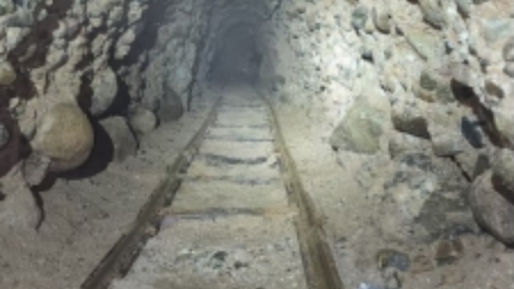 A tremendously long drug smuggling tunnel had tracks, electricity, and ventilation systems