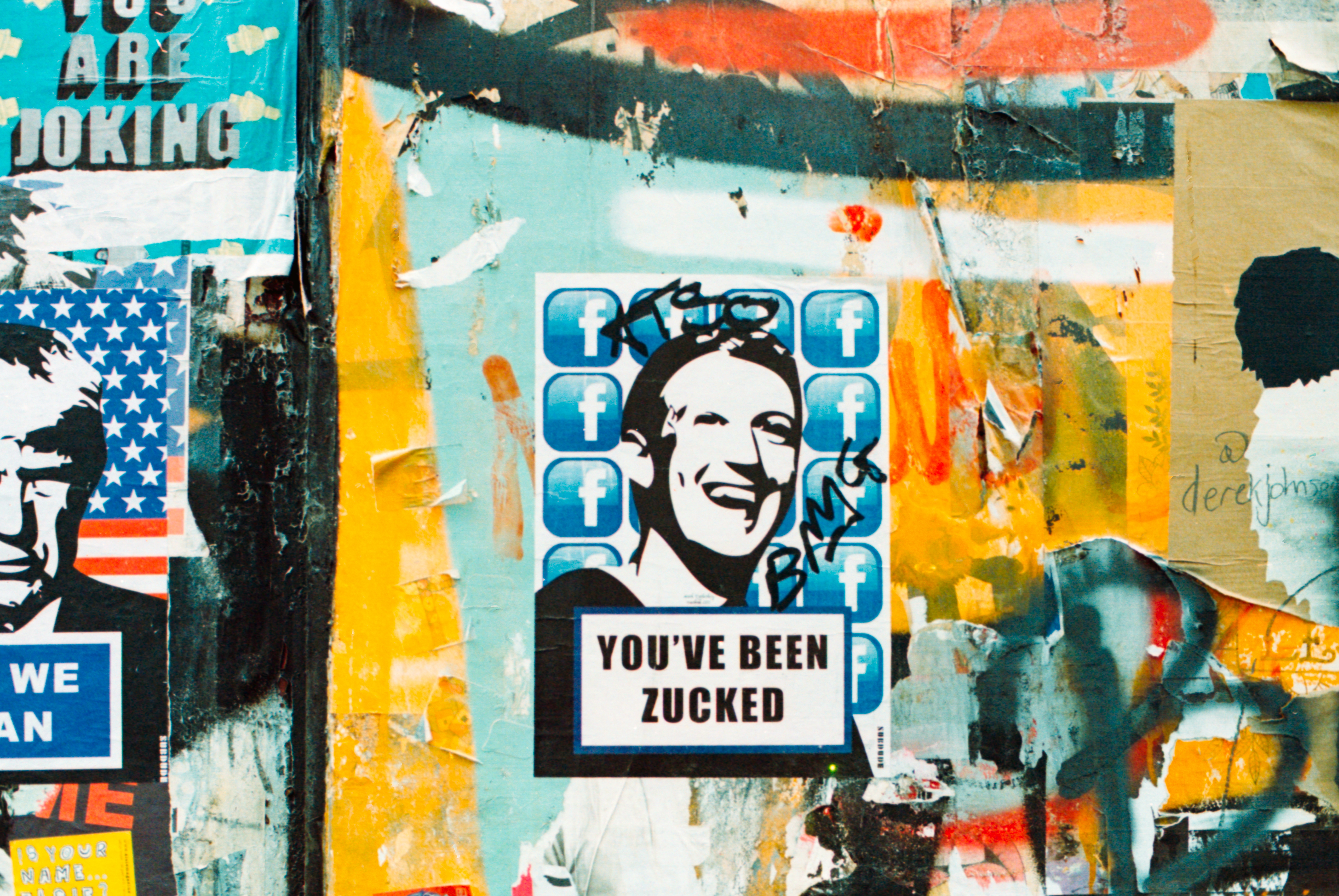 London street art showing a graphic image of Mark Zuckerberg surrounded by Facebook icons and the phrase