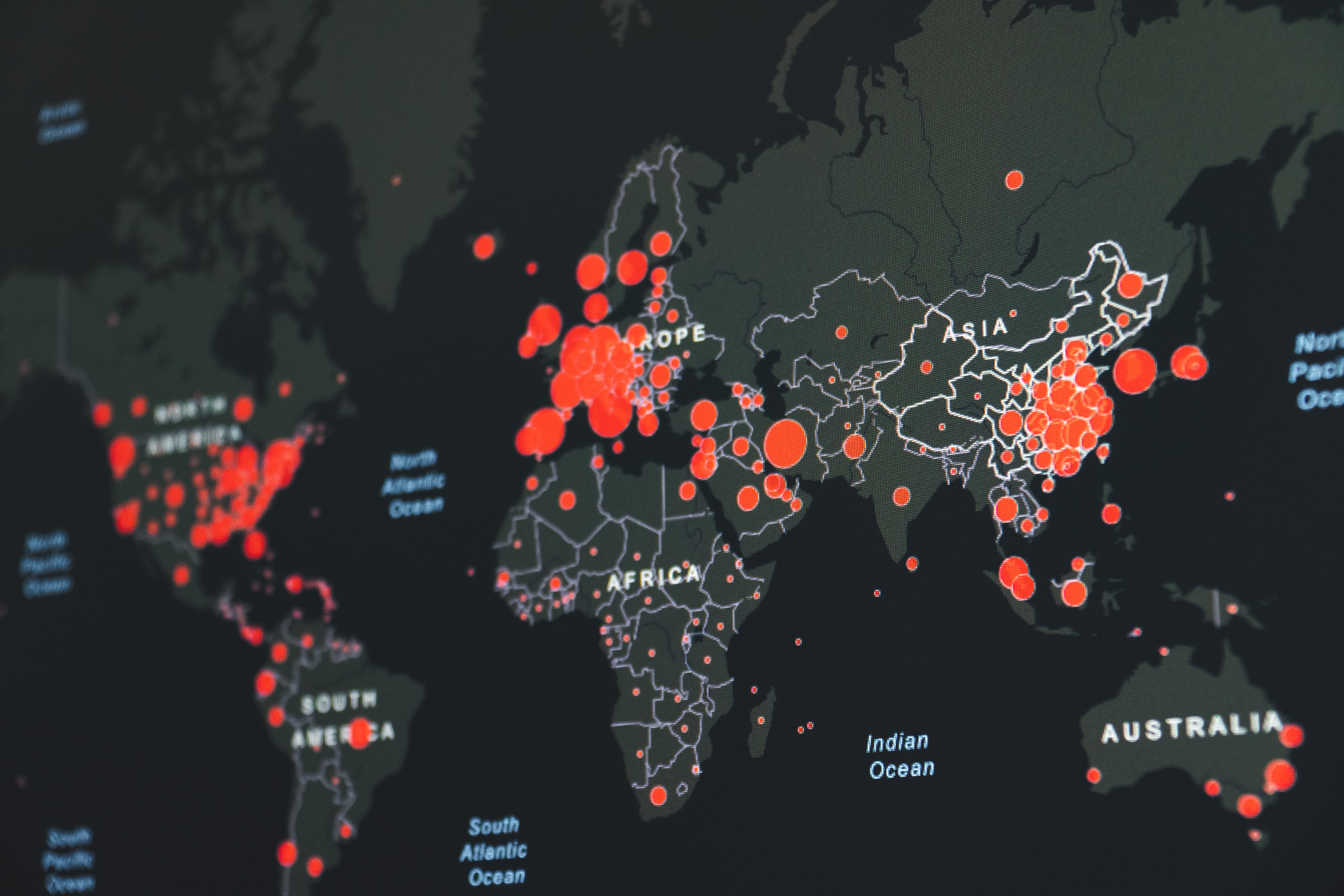 A world map of coronavirus rates with red circles showing the severity in each country.