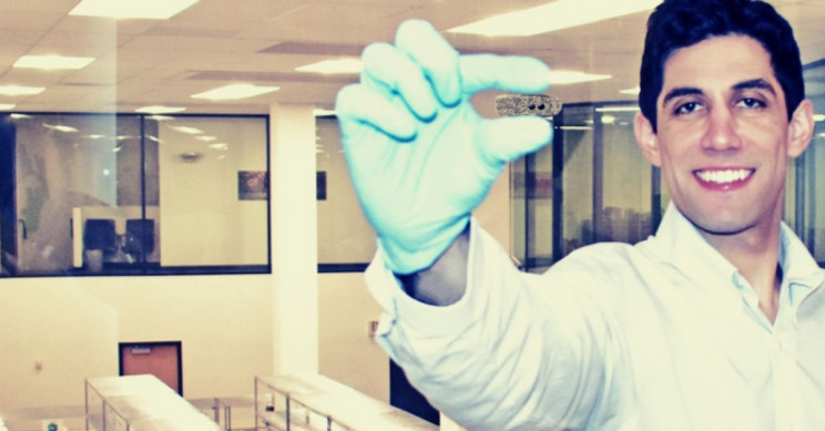 xenco-medical-scientist-holds-implant Xenco Medical Scientist Holds Implant