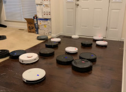 Watch 25 Robot Vacuums Attack A Bunch of Spilled Rice At Once