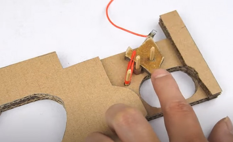 diy cardboard tommy gun trigger in place