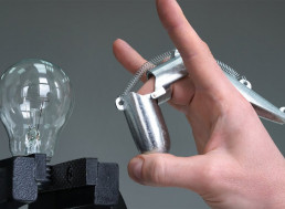 This Metal Finger Machine's Flick Can Shatter a Light Bulb