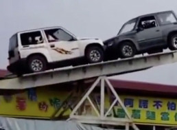 Watch These People Play a Car Balancing Game on a Giant Seesaw