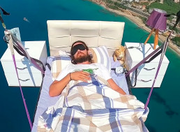 Paraglider Sleeps on a Bed While Flying Over the Mediterranean Sea
